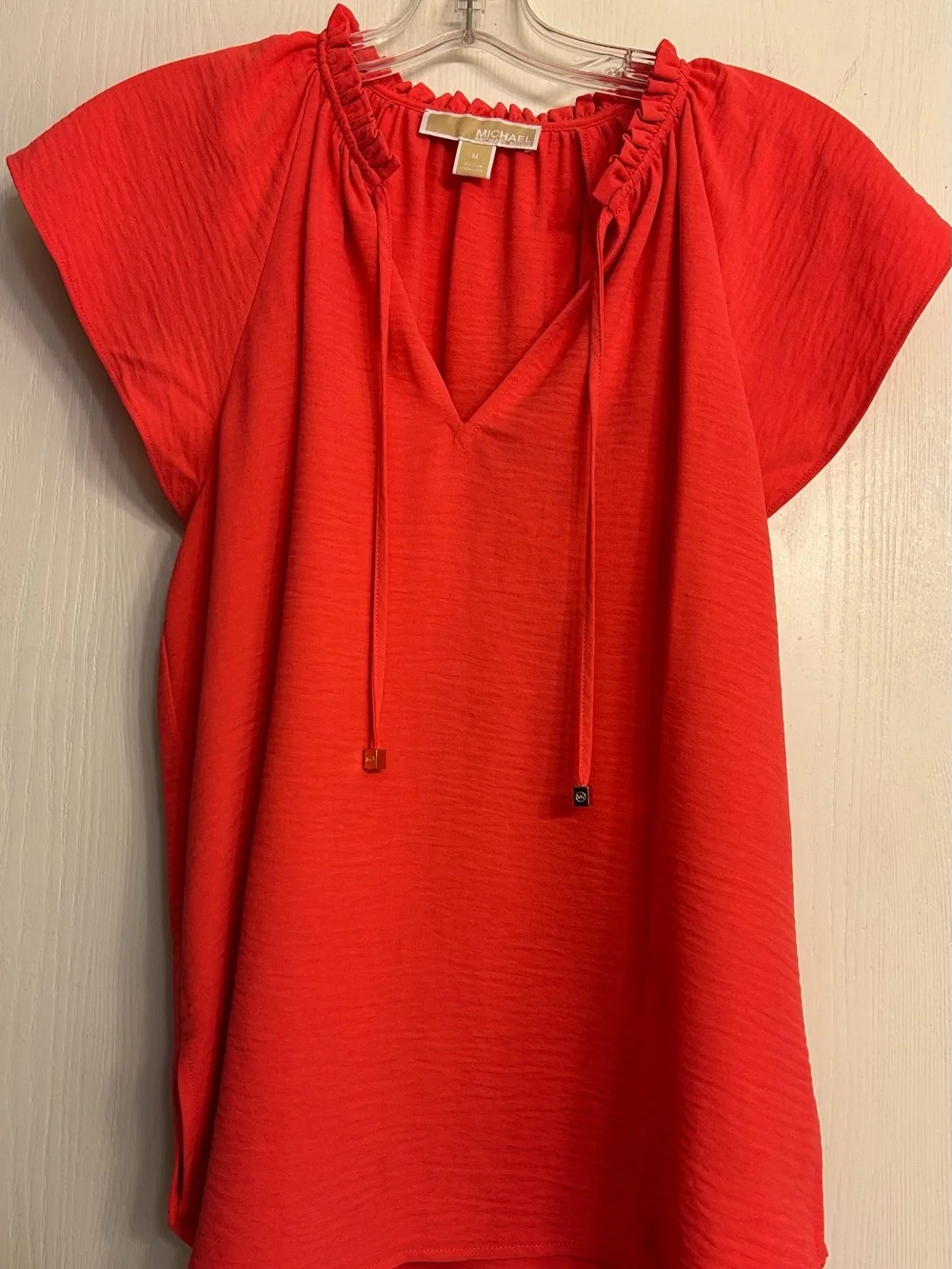 MICHAEL KORS NWOT Bright Coral Ruffle Tie Neck Ladies Cap-Sleeve Blouse Size M.